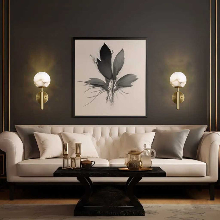 Two luxurious Aelios Wall Lights are on display in the living room where they hang on the walls on either side of the modern sofa.